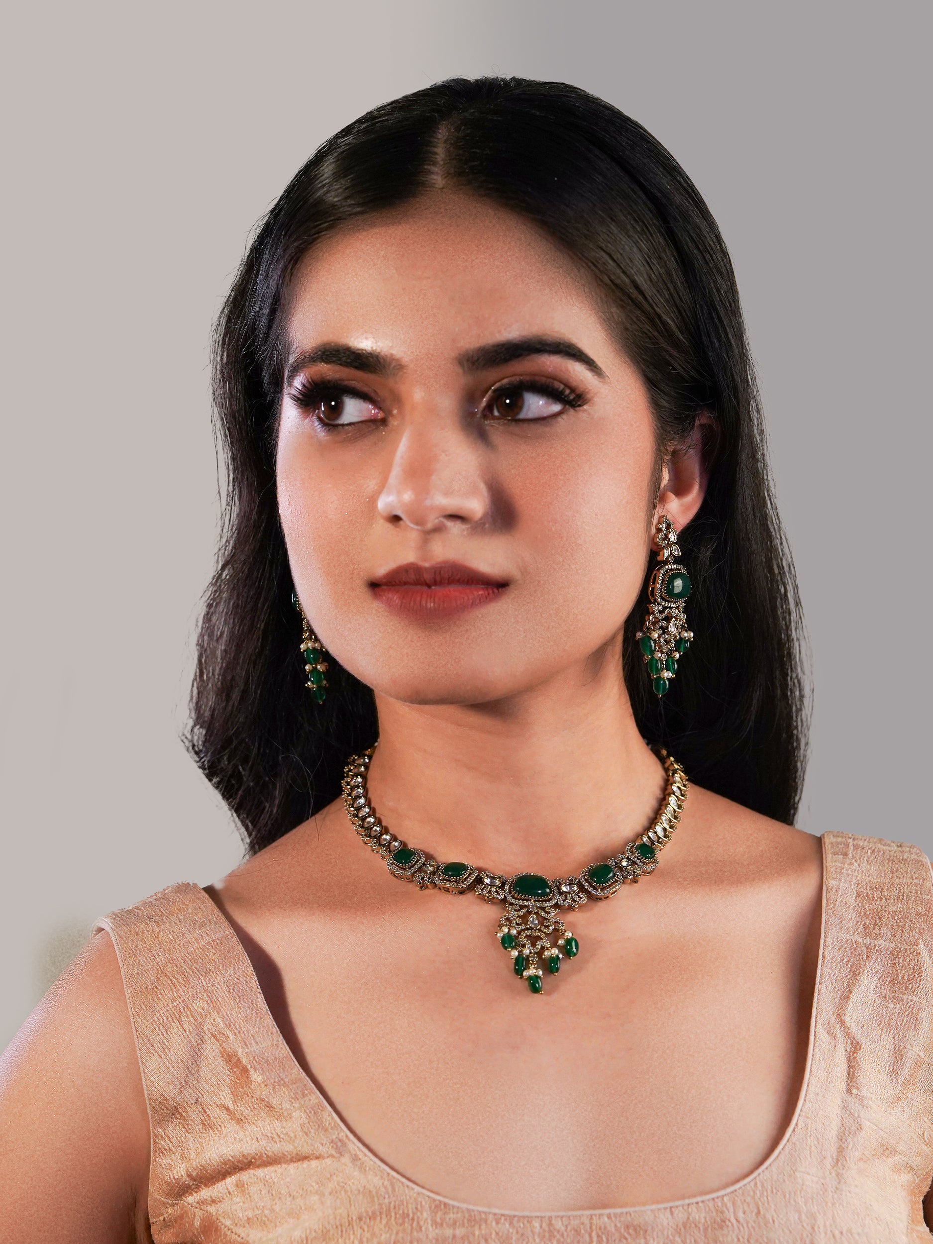 Itrani Aarohi Emerald Green Stone Clear Polki Stone Necklace Set – Traditional Brass Jewelry with Modern Elegance