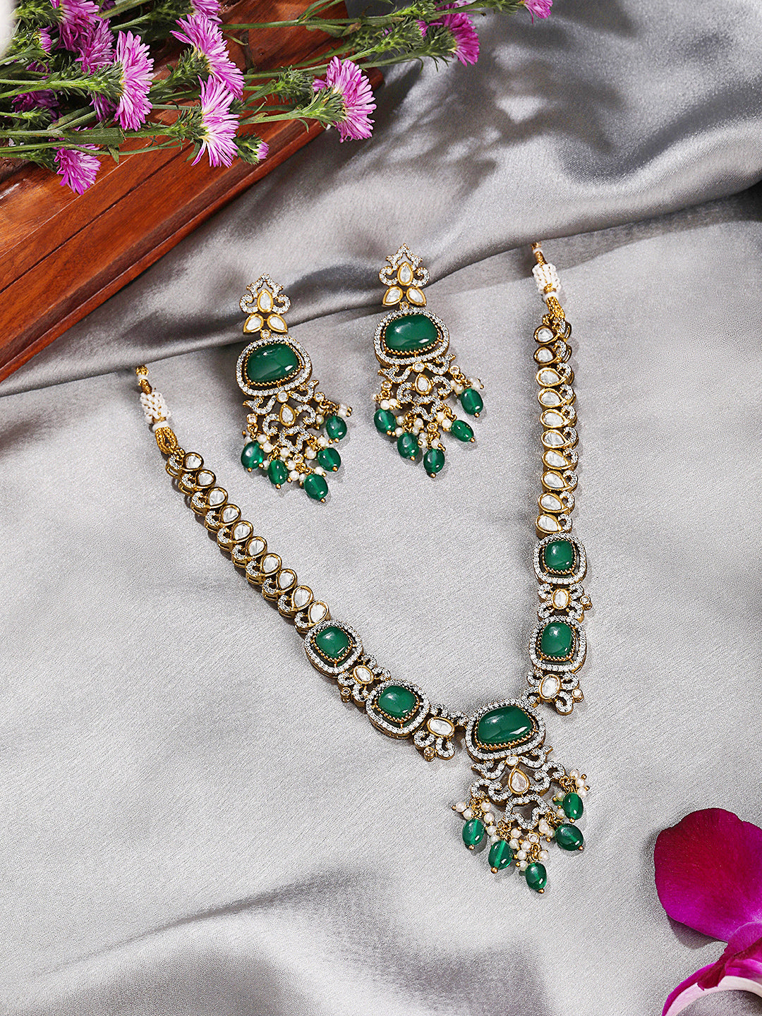 Itrani Aarohi Emerald Green Stone Clear Polki Stone Necklace Set – Traditional Brass Jewelry with Modern Elegance